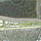 The illustrated white buildings to the left are the proposed second phase of the Gehry-designed complex, with the green roof of the new building to their right, and the old Facebook HQ to the far upper right corner